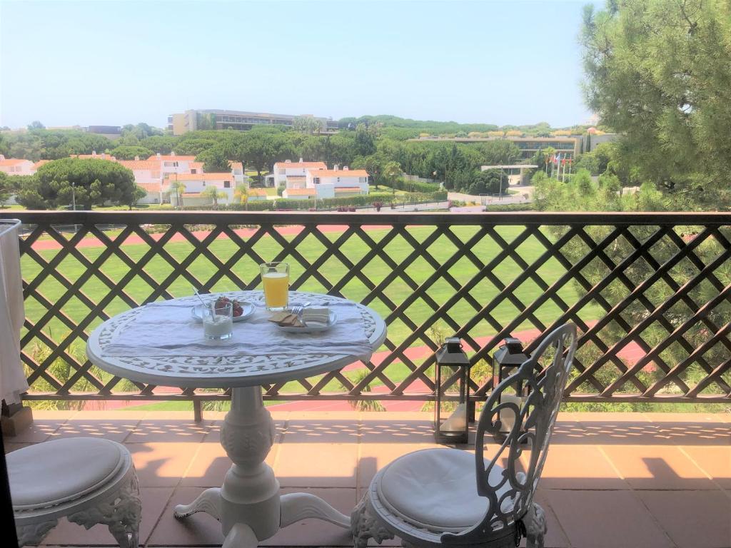 a table and chairs on a balcony with a view at Faraway Falésia in Olhos de Água