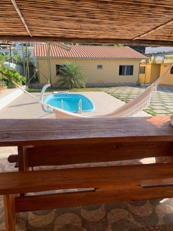 a hammock in front of a swimming pool at POUSADA FÊNIX in Viçosa