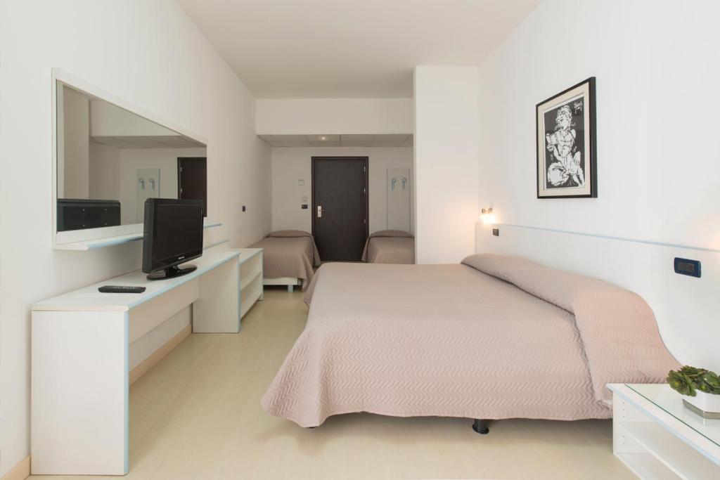 Postel nebo postele na pokoji v ubytování Grand Hotel Adriatico
