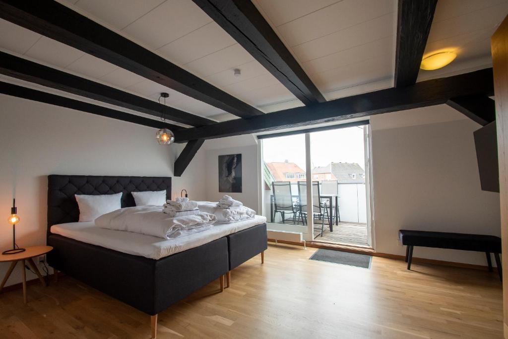 a bedroom with a large bed and a large window at Stylish two floor Deluxe Apartment - 2 bedroom in Sønderborg