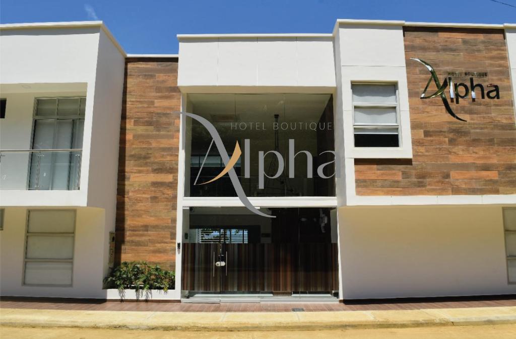 a building with a sign on the front of it at Alpha Hotel Boutique in Necoclí