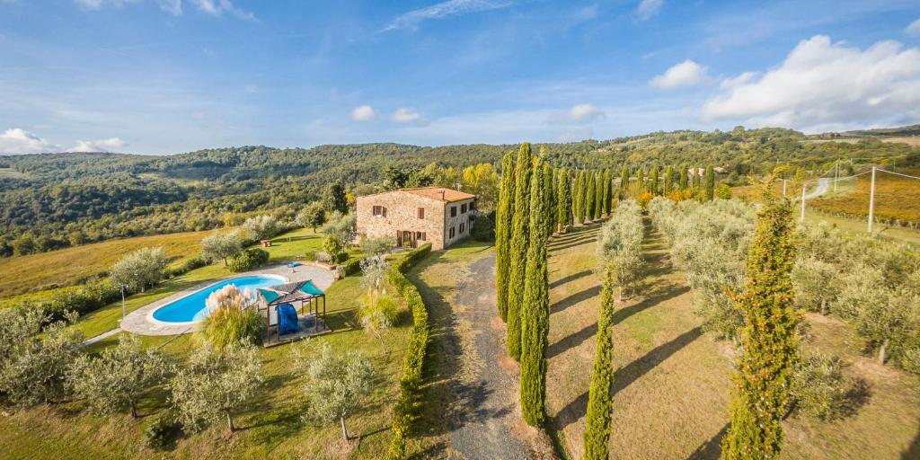 an aerial view of a house and a swimming pool at Podere Oliveta in Montecatini Val di Cecina