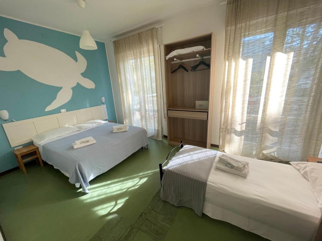 Postel nebo postele na pokoji v ubytování Hotel Aloha