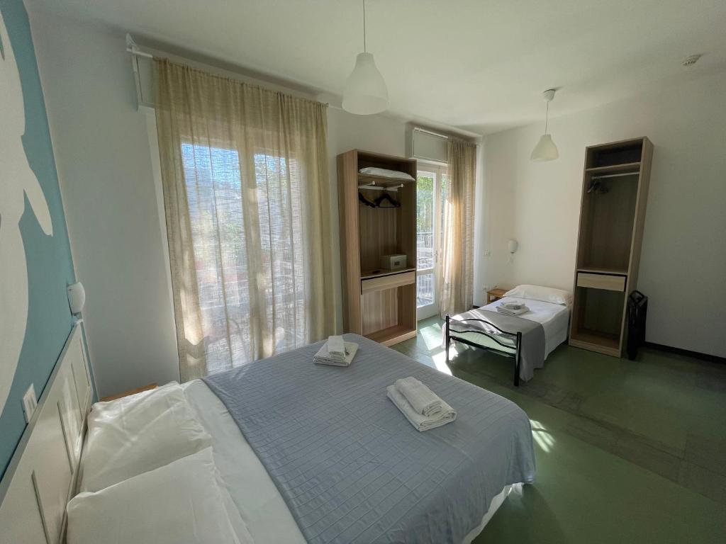 Postel nebo postele na pokoji v ubytování Hotel Aloha