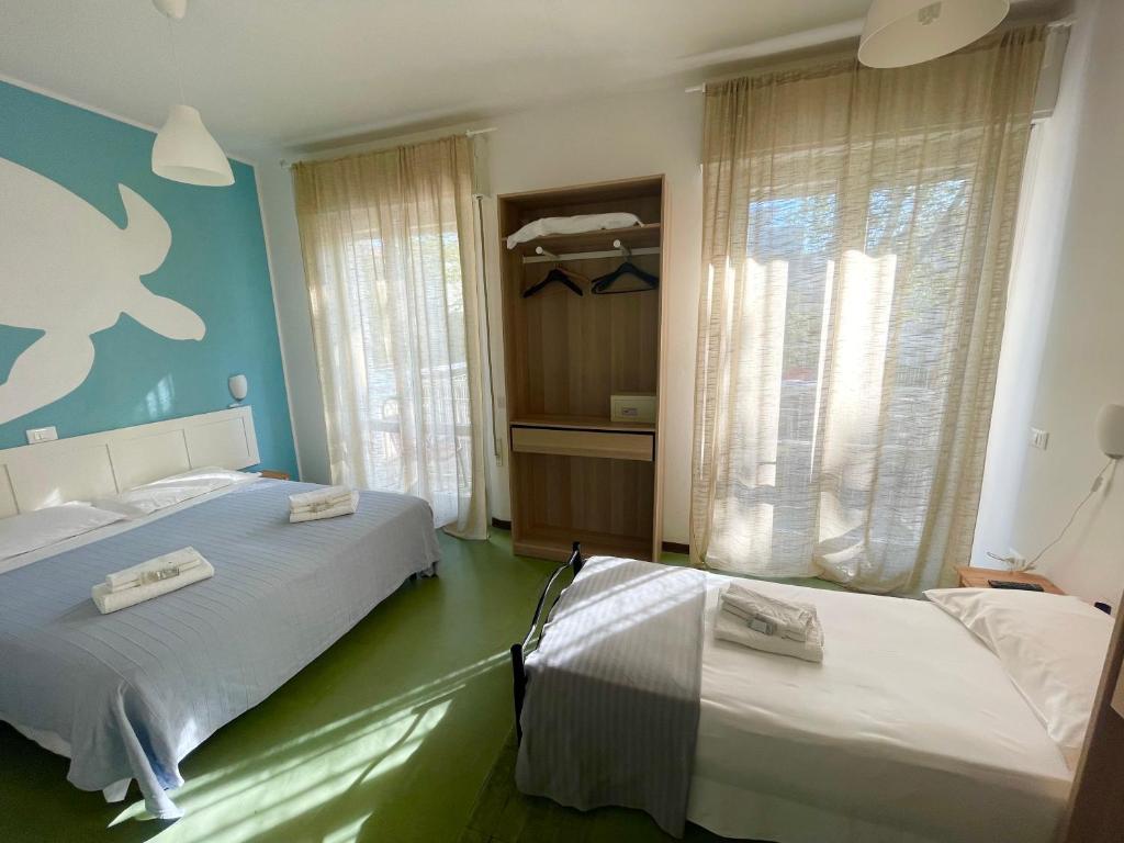 Postel nebo postele na pokoji v ubytování Hotel Aloha