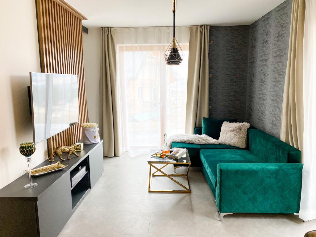 Televízia a/alebo spoločenská miestnosť v ubytovaní Top Hill apartmán - Kubínska hoľa