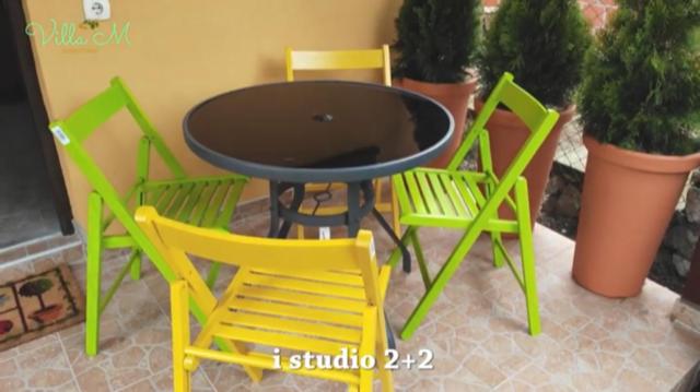four chairs and a table and a table and chairs at Villa M in Vinci