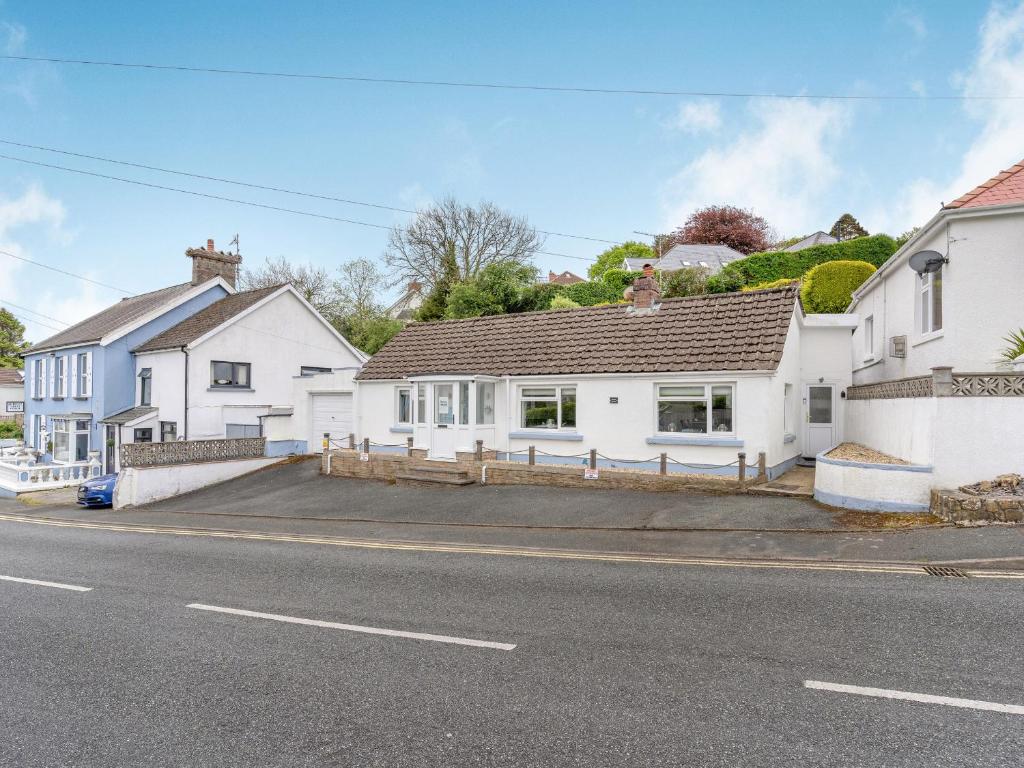 a row of white houses on a street at Captiva Cottage in Saundersfoot