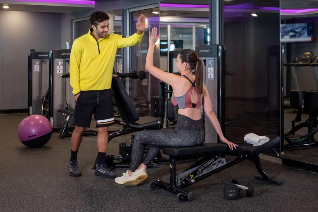 a man giving a woman a high five in a gym at YOTEL Istanbul Airport, City Entrance in Istanbul