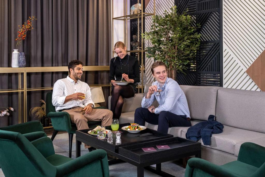 a group of people sitting in a living room at YOTEL Istanbul Airport, City Entrance in Istanbul