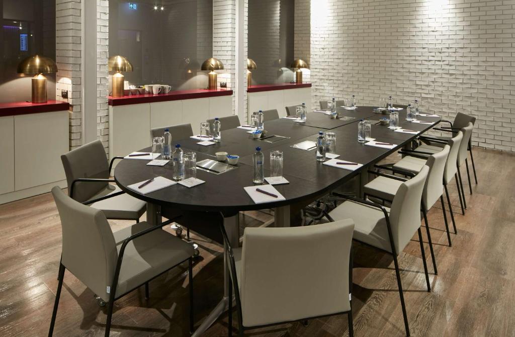 a large dining room with a long table and chairs at YOTEL Istanbul Airport, City Entrance in Istanbul