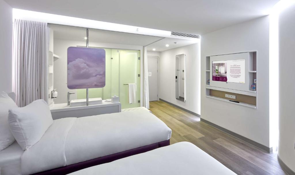 a white room with a bed and a tv at YOTEL Istanbul Airport, City Entrance in Istanbul