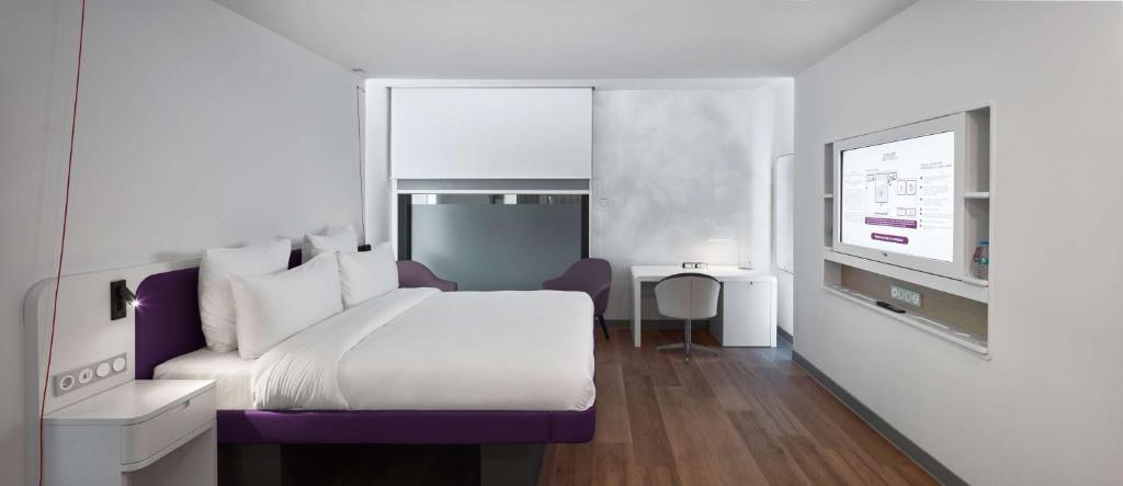 a hotel room with a bed and a tv at YOTEL Istanbul Airport, City Entrance in Istanbul
