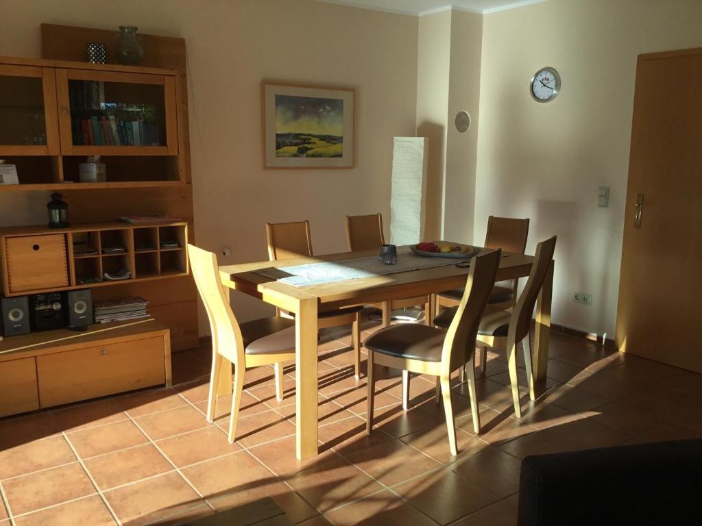 a dining room with a wooden table and chairs at Dycke Haus 6 in Zudar