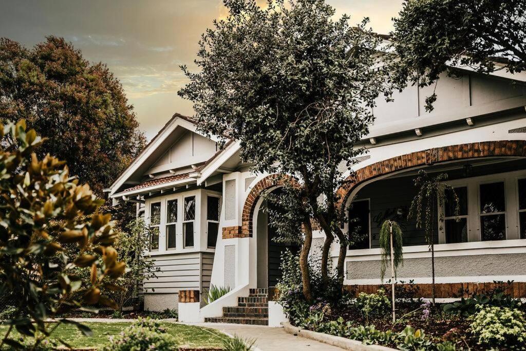 a white house with a tree in front of it at Gilbert by Whiskey June in Maryborough