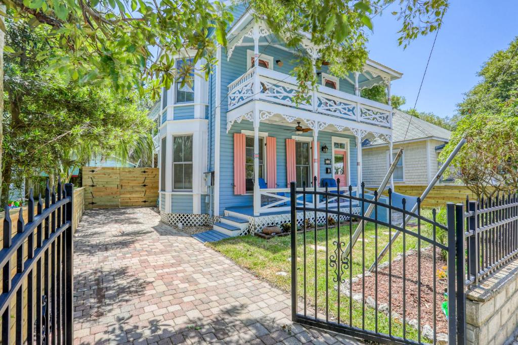 a blue house with a gate in front of it at Victorian Haven in Saint Augustine