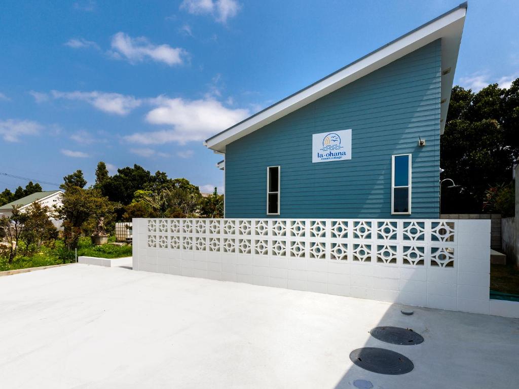 a blue building with a white fence in front of it at la ohana～瀬底島～（2022年OPEN） in Okinawa City