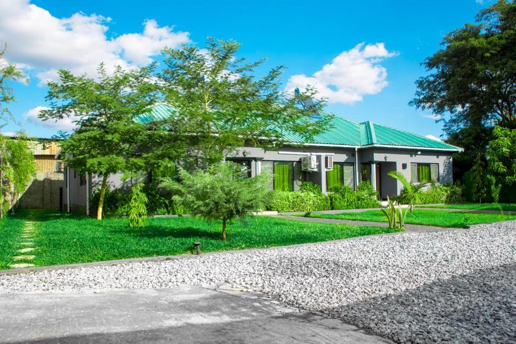 a house with a gravel driveway in front of it at BlueGreens Accommodation in Ndola