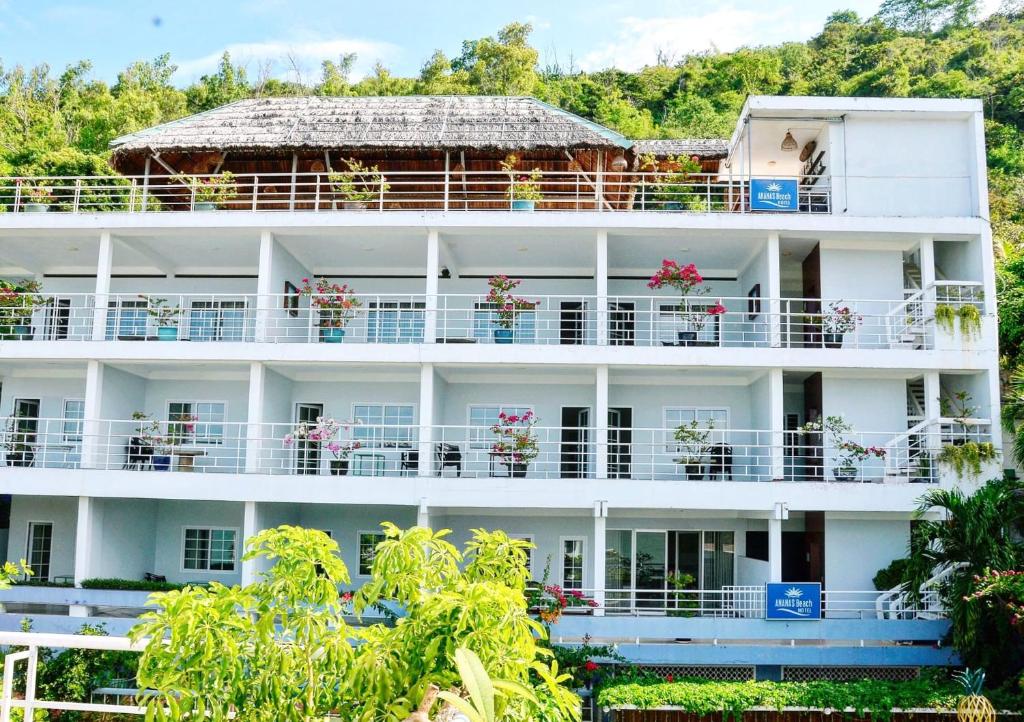 a large white building with flowers on the balconies at Ananas Beach Hotel in Vung Tau