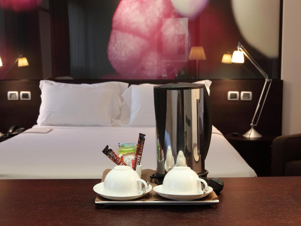 Postel nebo postele na pokoji v ubytování Postumia Hotel Design