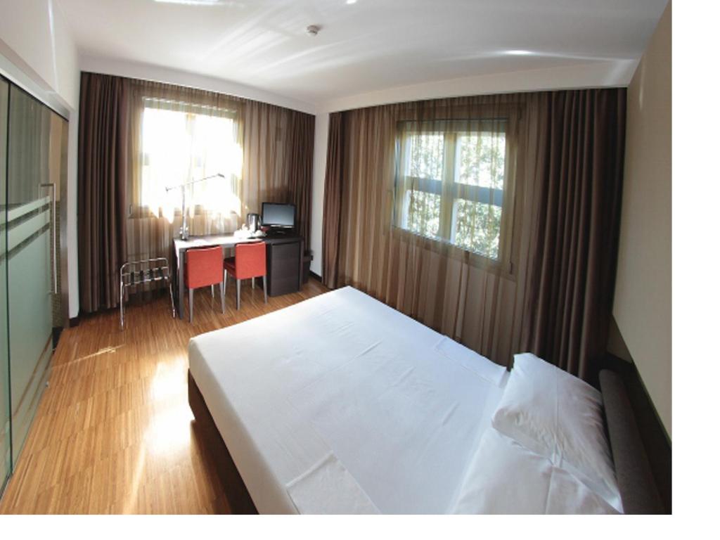 Postel nebo postele na pokoji v ubytování Postumia Hotel Design