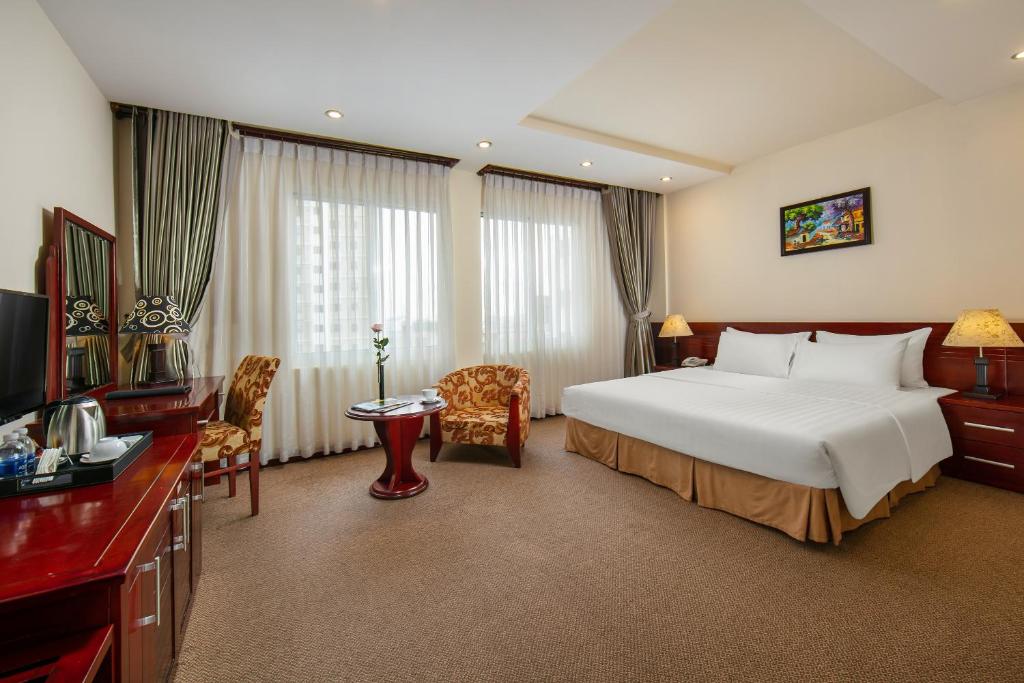Postel nebo postele na pokoji v ubytování A25 Hotel - 705 Lac Long Quan