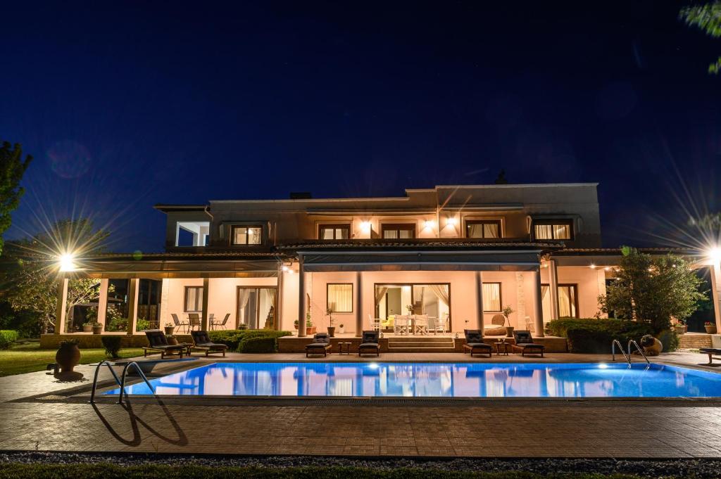 a house with a swimming pool at night at Villa Belvedere in Alexandroupoli