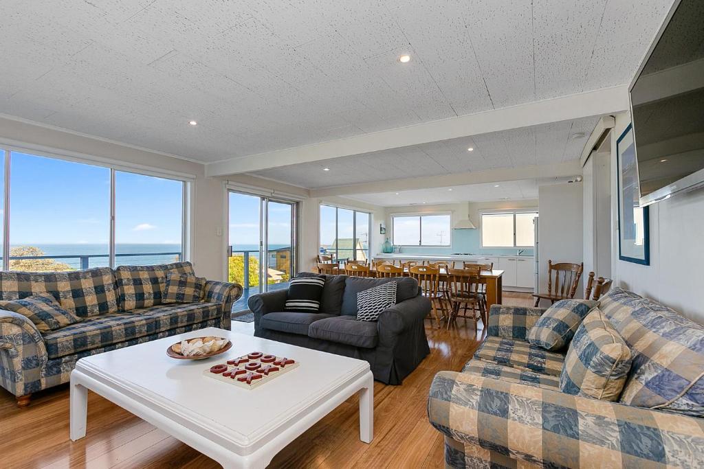 a living room with couches and a table at Mirimar in Apollo Bay