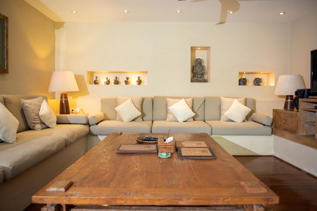 a living room with a couch and a coffee table at Sienna Villas Seminyak in Seminyak