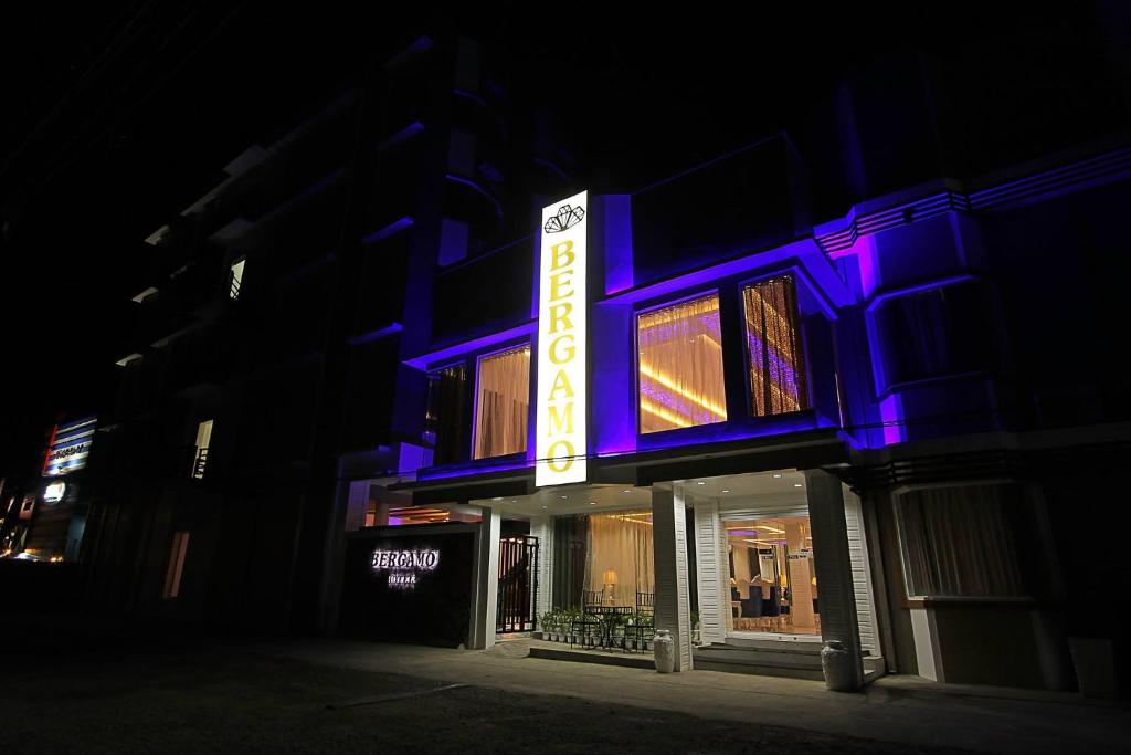 a building with a neon sign in the dark at Bergamo Hotel in Lingayen