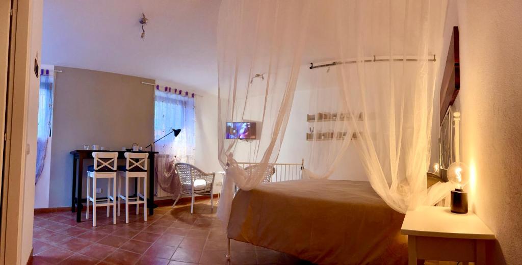 a bedroom with a bed and a table with a television at Agriturismo I Prati di Venere in Sesta Godano
