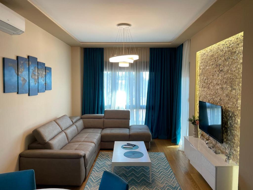a living room with a couch and a tv at Apartment Sofia, City Centar in Podgorica