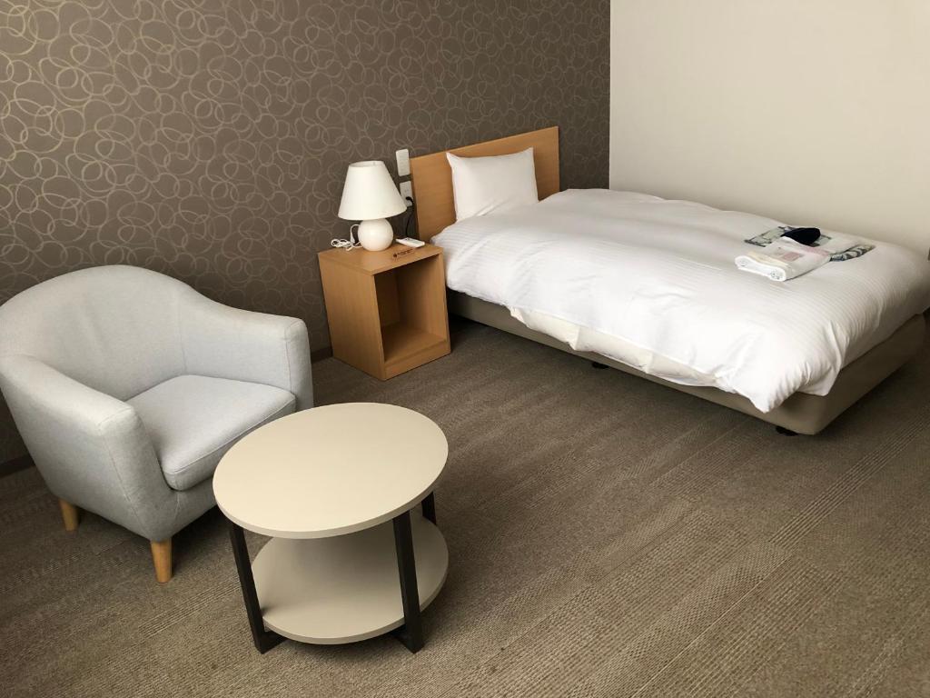 Postel nebo postele na pokoji v ubytování Sun Plaza Hotel Fuji Lake Yamanaka