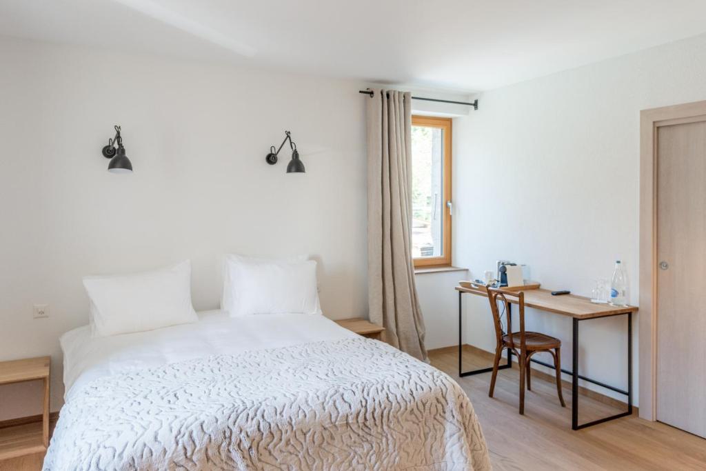 Postel nebo postele na pokoji v ubytování La Ferme du Lignon