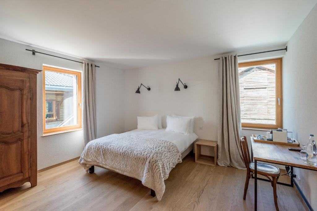 Postel nebo postele na pokoji v ubytování La Ferme du Lignon