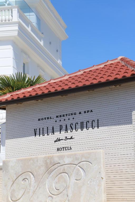 a sign on a wall in front of a building at Hotel Villa Pascucci in Durrës