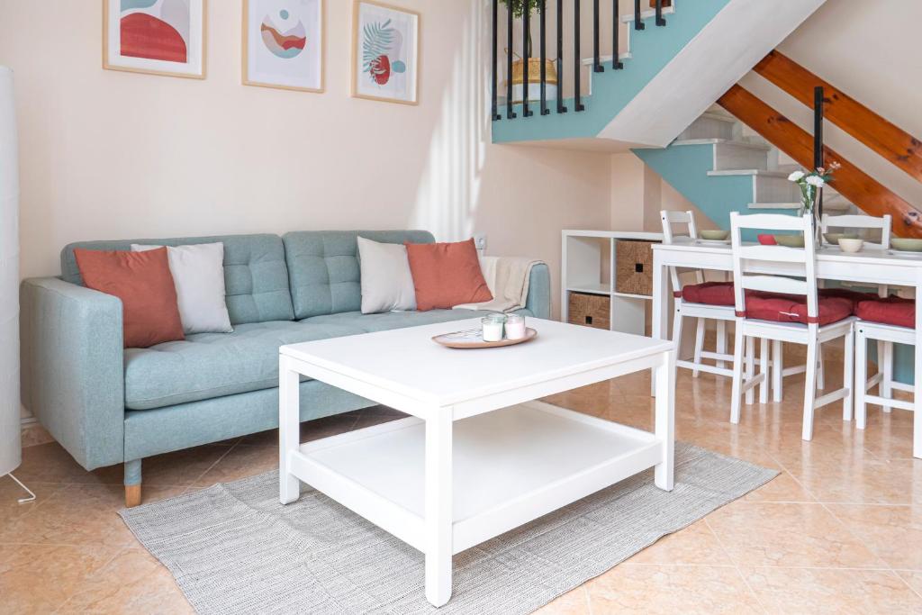 a living room with a couch and a table at Apartamento AGUADULCE in Sanlúcar de Barrameda