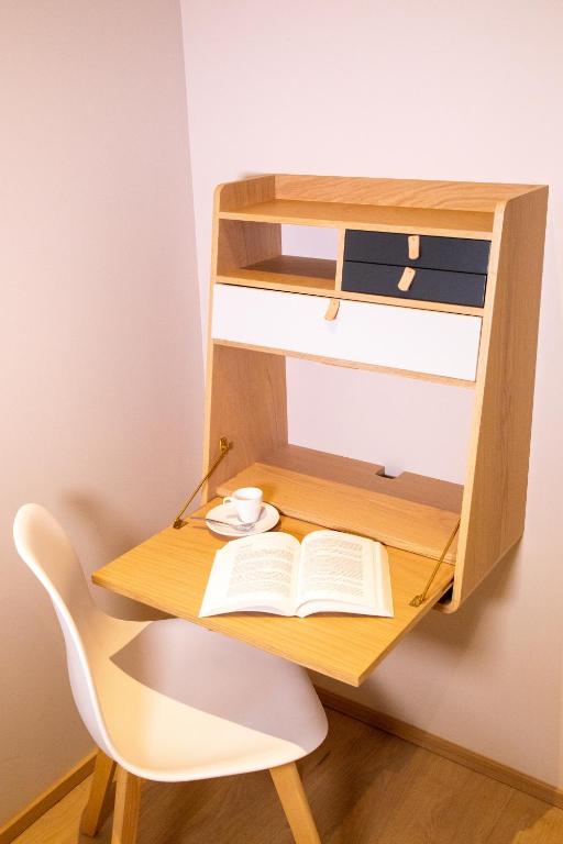a wooden desk with an open book and a chair at Villa Saint Enogat in Aix-les-Bains