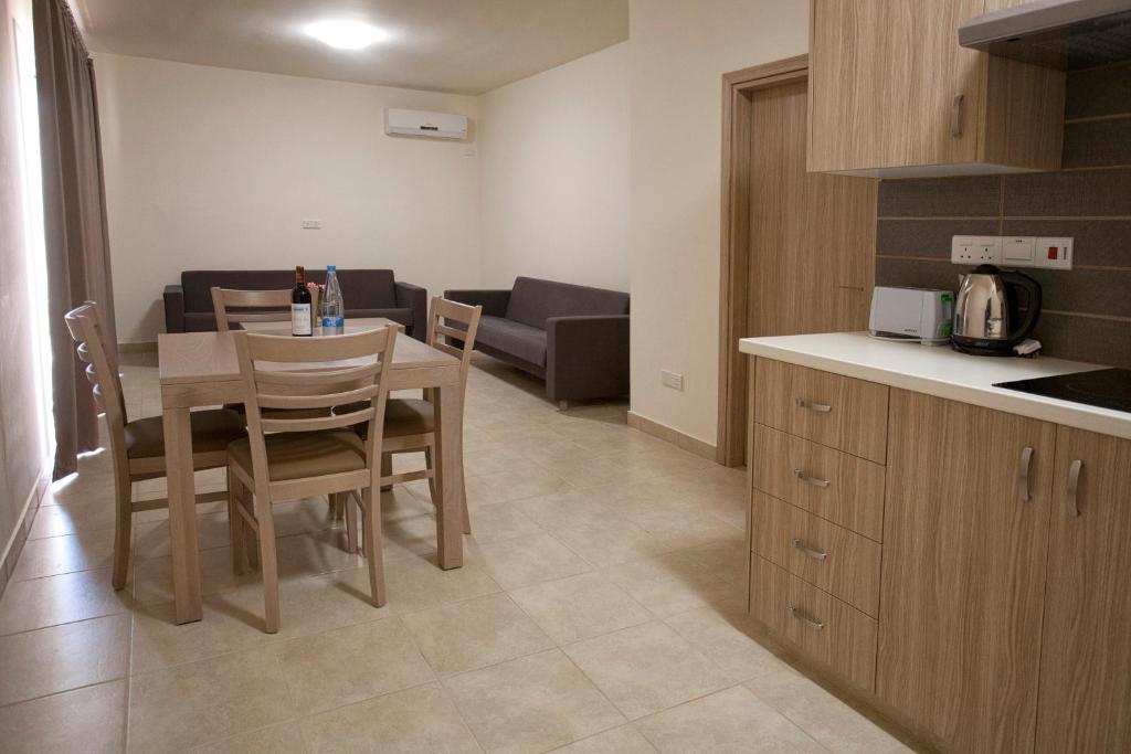 a kitchen and dining room with a table and chairs at Makronisos Village in Ayia Napa