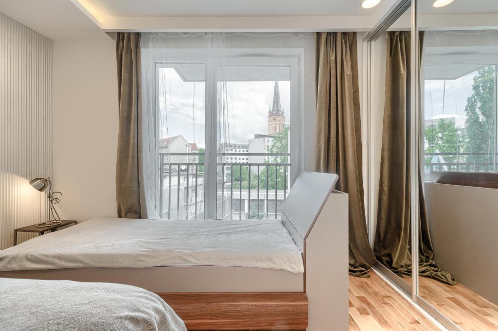 Posteľ alebo postele v izbe v ubytovaní Apartament Prezydencki bulwary Stare Miasto Apartamenty No 1