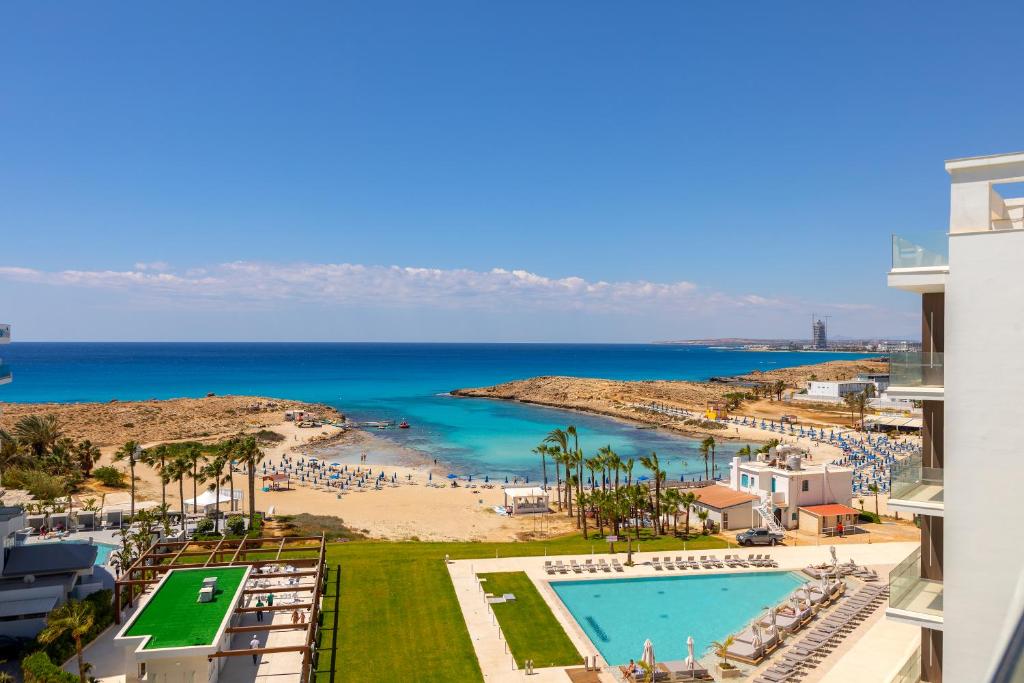 a view of the beach from the balcony of a resort at Chrysomare Beach Hotel & Resort in Ayia Napa