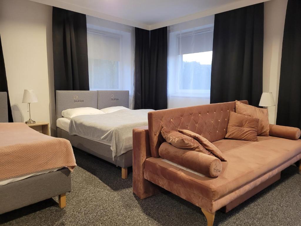 Posteľ alebo postele v izbe v ubytovaní Silesia Apartments