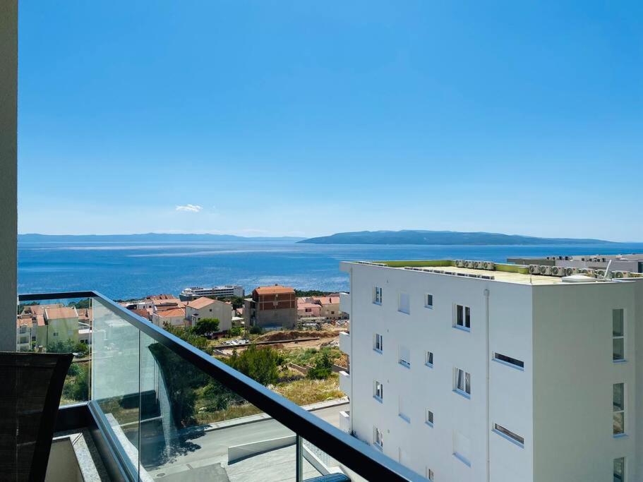 a view of the ocean from a balcony of a building at Sunrise Makarska in Makarska