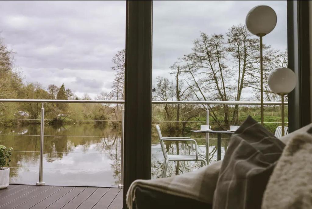a room with a view of a lake through a window at Water Cabin With Water Sports Equipment and Bikes, Bath in Bristol