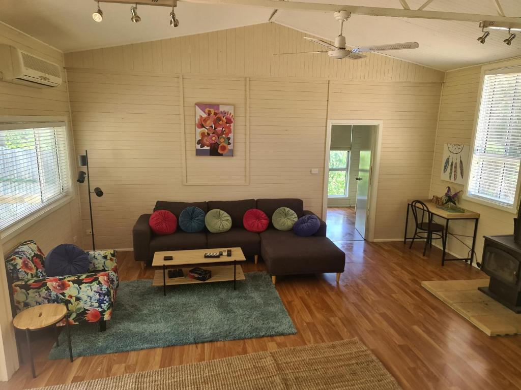 a living room with a couch and a table at Kooloora Cottage in Tumbarumba