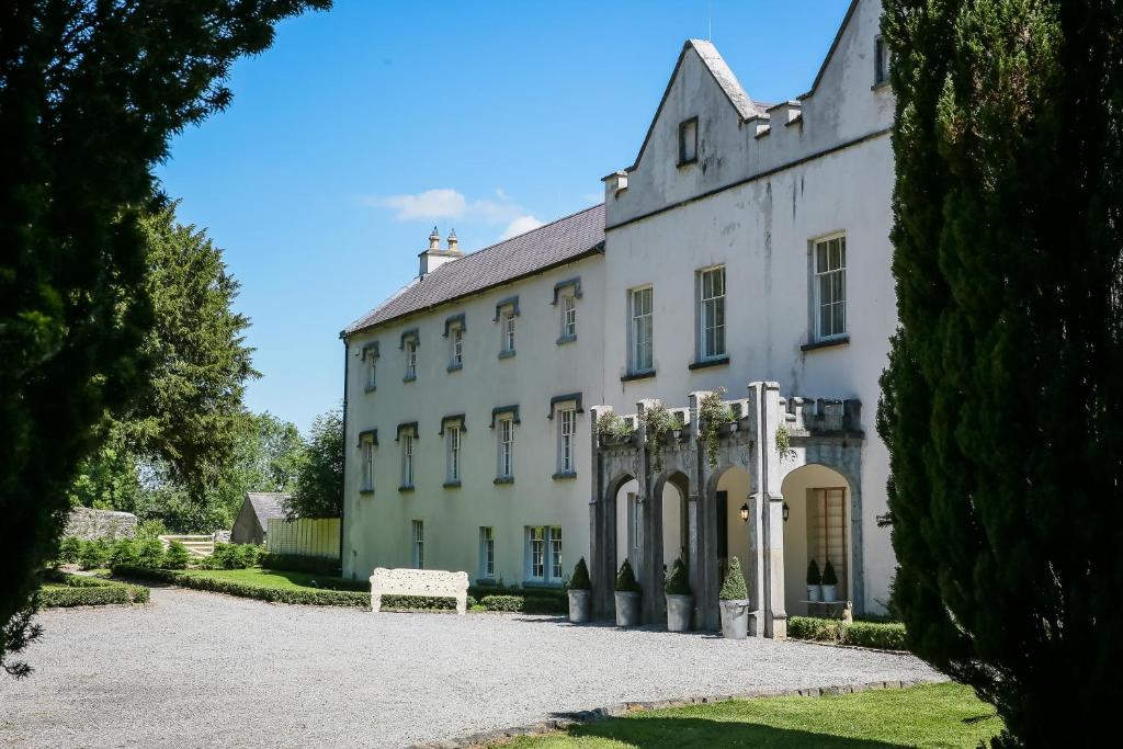 a large white building with a pathway in front of it at Annamult Country House Estate in Kilkenny