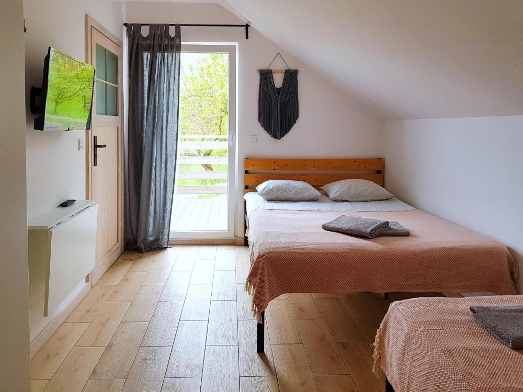 1 dormitorio con 2 camas y ventana en Salve Regina, en Sandomierz