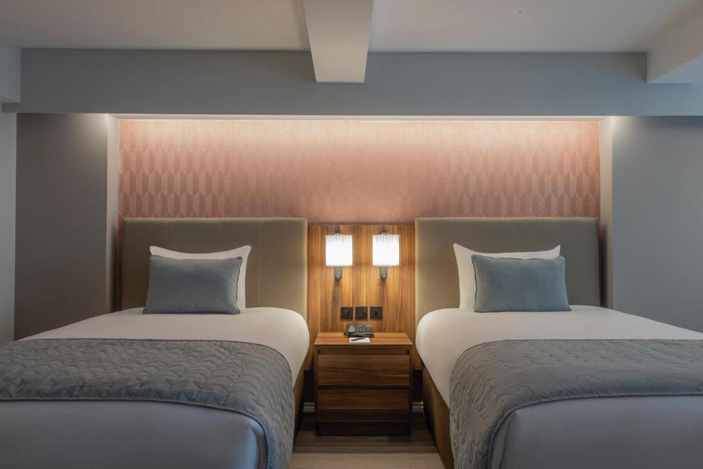 Voodi või voodid majutusasutuse Riu Plaza The Gresham Dublin toas