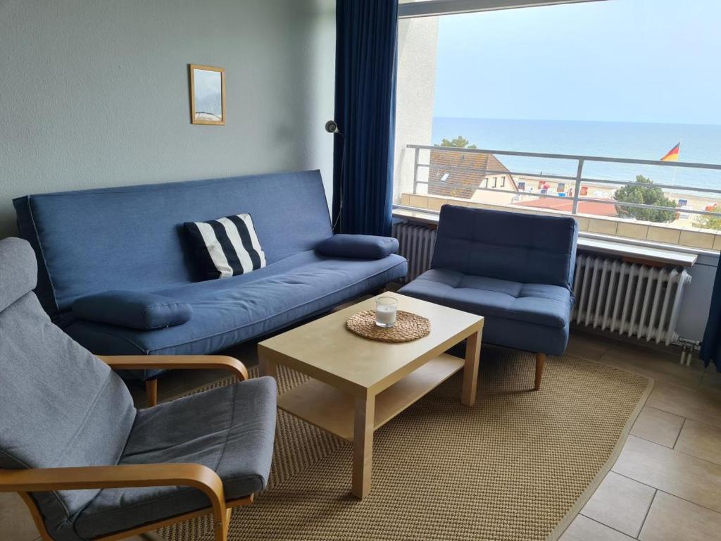 a living room with a couch and chairs and a table at Strandhotel Wohnung 48 in Dahme