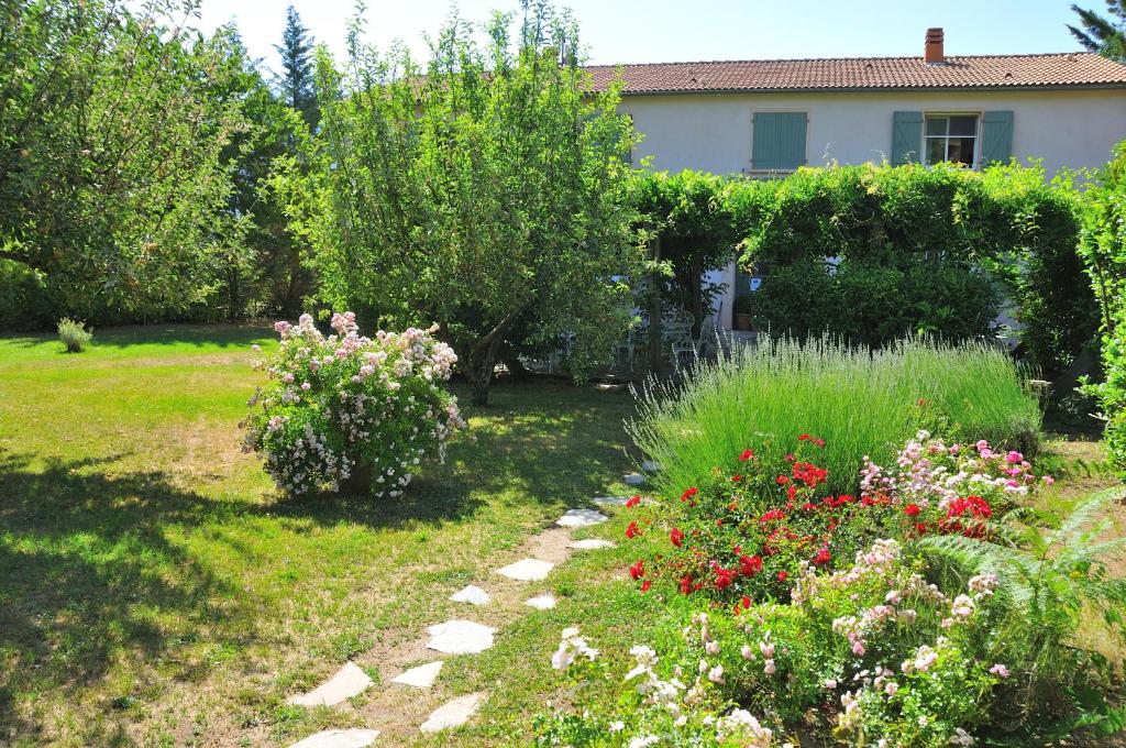 a garden with flowers and plants in front of a house at Casa Balduina in Calacuccia